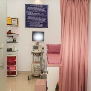 Private diagnostic room with medical equipment and privacy curtain at Sara Diagnostics, Kharadi Pune