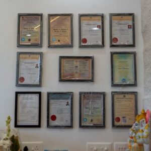 Wall display of framed certificates and clinic credentials at Sara Diagnostics, Kharadi Pune